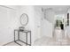Entryway featuring white tiled floor, glass table, and stairwell leading to the second floor at 58 Ridgeport Rd, Clover, SC 29710