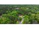 Aerial view of home nestled within a forest setting, surrounded by green landscape at 6265 Riviera Run Estates Dr, Hickory, NC 28601