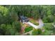 Aerial view of a stunning home nestled in a lush forest, featuring a long driveway and manicured landscaping at 6265 Riviera Run Estates Dr, Hickory, NC 28601