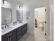 Clean bathroom with modern double vanity, matte black fixtures, and separate toilet room at 6265 Riviera Run Estates Dr, Hickory, NC 28601