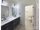 Clean bathroom with modern double vanity, matte black fixtures, and separate toilet room at 6265 Riviera Run Estates Dr, Hickory, NC 28601