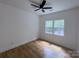 Bright, this bedroom features a ceiling fan, hardwood floors, and two large windows providing plenty of natural light at 6265 Riviera Run Estates Dr, Hickory, NC 28601