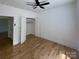 This bedroom boasts hardwood floors, fresh paint, a ceiling fan, and a walk-in closet at 6265 Riviera Run Estates Dr, Hickory, NC 28601