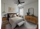 Cozy bedroom showcasing neutral tones, complemented by a ceiling fan, window with curtains, and stylish decor at 6265 Riviera Run Estates Dr, Hickory, NC 28601