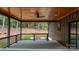 A rear covered patio overlooking a grass yard and a wooded backdrop at 6265 Riviera Run Estates Dr, Hickory, NC 28601