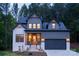 Inviting two-story home, showcasing great curb appeal with its well-lit entrance and complementary textures at 6265 Riviera Run Estates Dr, Hickory, NC 28601