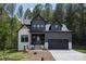Charming two-story home featuring a modern facade, lush landscaping, and inviting front entrance at 6265 Riviera Run Estates Dr, Hickory, NC 28601