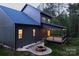 Charming exterior view of a two-story home featuring a cozy fire pit and a covered deck at 6265 Riviera Run Estates Dr, Hickory, NC 28601