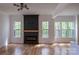 Bright living room featuring a modern fireplace, hardwood floors, and large windows offering scenic views at 6265 Riviera Run Estates Dr, Hickory, NC 28601
