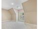 Empty bedroom with an attached balcony, neutral carpet, and clean walls at 703 Sainte Rose Ln, Charlotte, NC 28226