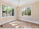Bonus room with large windows, hardwood flooring, and ample natural light at 703 Sainte Rose Ln, Charlotte, NC 28226