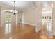 Spacious dining room with hardwood floors, chandelier, and arched entryways at 703 Sainte Rose Ln, Charlotte, NC 28226