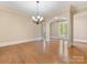 Formal dining room with hardwood floors, chandelier, and neutral paint palette at 703 Sainte Rose Ln, Charlotte, NC 28226