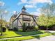 Charming Tudor-style home with well-manicured landscaping, brick accents, and detailed architectural features at 703 Sainte Rose Ln, Charlotte, NC 28226