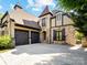Stunning home featuring a three-car garage, unique architectural details, and impeccable design at 703 Sainte Rose Ln, Charlotte, NC 28226