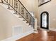 Beautiful foyer with high ceilings, hardwood floors, and custom iron staircase at 703 Sainte Rose Ln, Charlotte, NC 28226