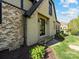 Stucco home featuring an elegant entryway and well-manicured lawn and front landscaping at 703 Sainte Rose Ln, Charlotte, NC 28226