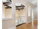 Upper hallway offering views to the main level of the home and bright windows at 703 Sainte Rose Ln, Charlotte, NC 28226