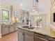 Large kitchen island features a stainless steel sink, granite countertop, and pendant lighting at 703 Sainte Rose Ln, Charlotte, NC 28226