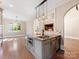 Kitchen island featuring granite countertop, stainless steel sink, and modern light fixtures at 703 Sainte Rose Ln, Charlotte, NC 28226