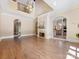 Spacious living room with a fireplace, hardwood floors, arched doorways, and a two-story ceiling at 703 Sainte Rose Ln, Charlotte, NC 28226