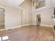 Open concept living space with hardwood floors and an open floorplan with view of the foyer at 703 Sainte Rose Ln, Charlotte, NC 28226