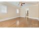 Spacious main bedroom with hardwood floors, large windows, and a ceiling fan at 703 Sainte Rose Ln, Charlotte, NC 28226