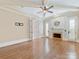 Bright main bedroom featuring a fireplace, hardwood floors, and high ceilings with exposed beams at 703 Sainte Rose Ln, Charlotte, NC 28226