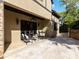 Inviting outdoor patio with stone flooring, stylish seating, and elegant architectural details at 703 Sainte Rose Ln, Charlotte, NC 28226