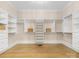 Well-organized walk-in closet offering shelving and drawers for ample storage at 703 Sainte Rose Ln, Charlotte, NC 28226