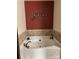 Bathroom features a garden tub with tiled walls and a wall mounted decorative accent piece at 715 N Church St # 613, Charlotte, NC 28202