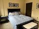 Bedroom featuring a black bed frame, blue bedding, and two end tables at 715 N Church St # 613, Charlotte, NC 28202