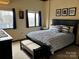 Bedroom featuring a black bed frame, blue bedding, and two windows with curtains at 715 N Church St # 613, Charlotte, NC 28202