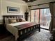 Tranquil bedroom with a comfortable bed, cityscape artwork, and a sliding glass door to a balcony at 715 N Church St # 613, Charlotte, NC 28202