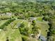 Picturesque aerial view of a tranquil countryside neighborhood nestled amidst lush greenery and mature trees at 7617 Pleasant Hill Church Rd, Marshville, NC 28103