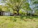 A spacious backyard featuring an outbuilding and large trees providing plenty of shade at 7617 Pleasant Hill Church Rd, Marshville, NC 28103