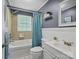 Bright bathroom features a tub-shower combo, decorative mirror, and a modern vanity at 7617 Pleasant Hill Church Rd, Marshville, NC 28103