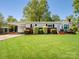 Charming single-story home features a lush green lawn, carport, and landscaped front at 7617 Pleasant Hill Church Rd, Marshville, NC 28103