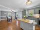 Open kitchen with island, custom cabinets, and stainless steel appliances at 7617 Pleasant Hill Church Rd, Marshville, NC 28103