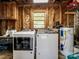 Wood-paneled laundry room with washer, dryer, and water heater at 7617 Pleasant Hill Church Rd, Marshville, NC 28103