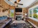 Cozy living room featuring a stone fireplace and wood-paneled walls at 7617 Pleasant Hill Church Rd, Marshville, NC 28103