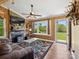 Cozy living room featuring a stone fireplace and wood-paneled walls at 7617 Pleasant Hill Church Rd, Marshville, NC 28103