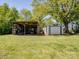 Spacious backyard featuring two outdoor utility buildings for storing yard equipment and tools at 7617 Pleasant Hill Church Rd, Marshville, NC 28103