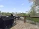 Wooden deck with a gas grill and a view of the tree line at 807 Oak Manor Se Dr, Concord, NC 28025