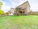 Spacious backyard with a deck, shed, green grass and a wooden fence at 807 Oak Manor Se Dr, Concord, NC 28025