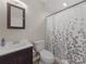 Clean bathroom featuring a modern vanity, toilet, and shower with a stylish shower curtain at 807 Oak Manor Se Dr, Concord, NC 28025