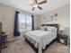 Bedroom featuring neutral walls, a ceiling fan, a TV, and drawers under the bed at 807 Oak Manor Se Dr, Concord, NC 28025