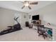 Bedroom featuring neutral walls, a ceiling fan, a TV, and home gym equipment at 807 Oak Manor Se Dr, Concord, NC 28025