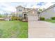 Charming two-story home with a well-manicured lawn, two car garage and a basketball hoop at 807 Oak Manor Se Dr, Concord, NC 28025