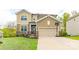Charming two-story home with a well-manicured lawn, two car garage and a basketball hoop at 807 Oak Manor Se Dr, Concord, NC 28025